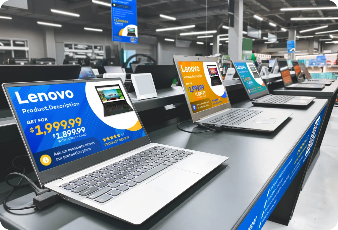 Row of Lenovo laptops on display tables in a modern electronics store with promotional price tags.