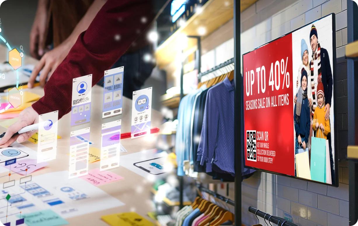 Digital interface of app design overlays a person working with sketches on a table in a clothing store with a sale sign offering up to 40% off on a screen